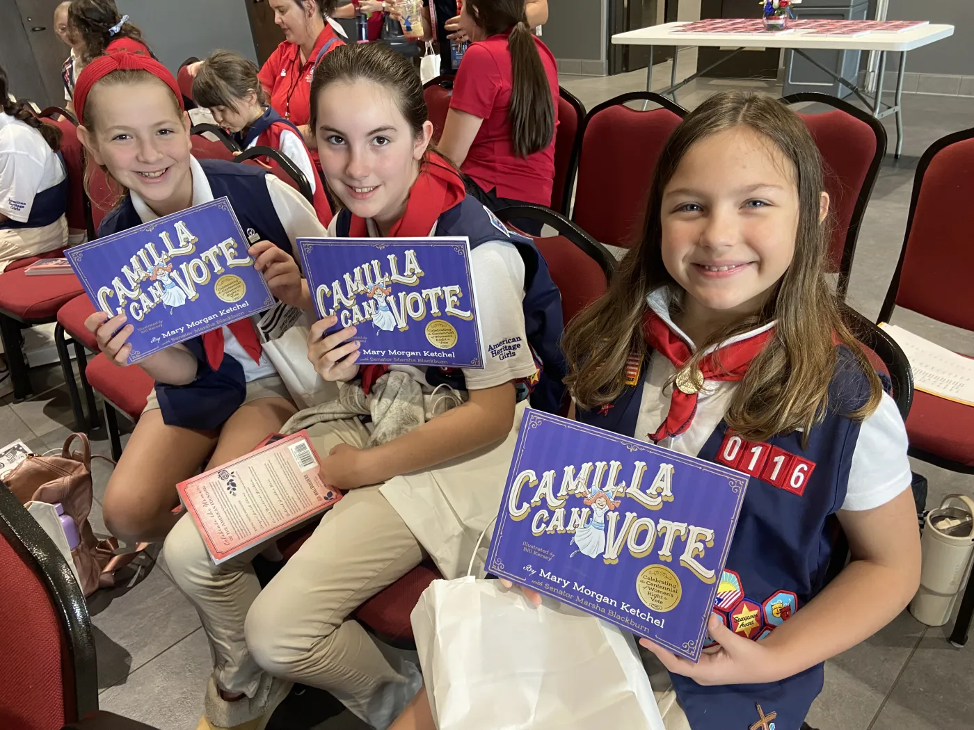 American Heritage Girls troop members holding their donated copies of Camilla Can Vote