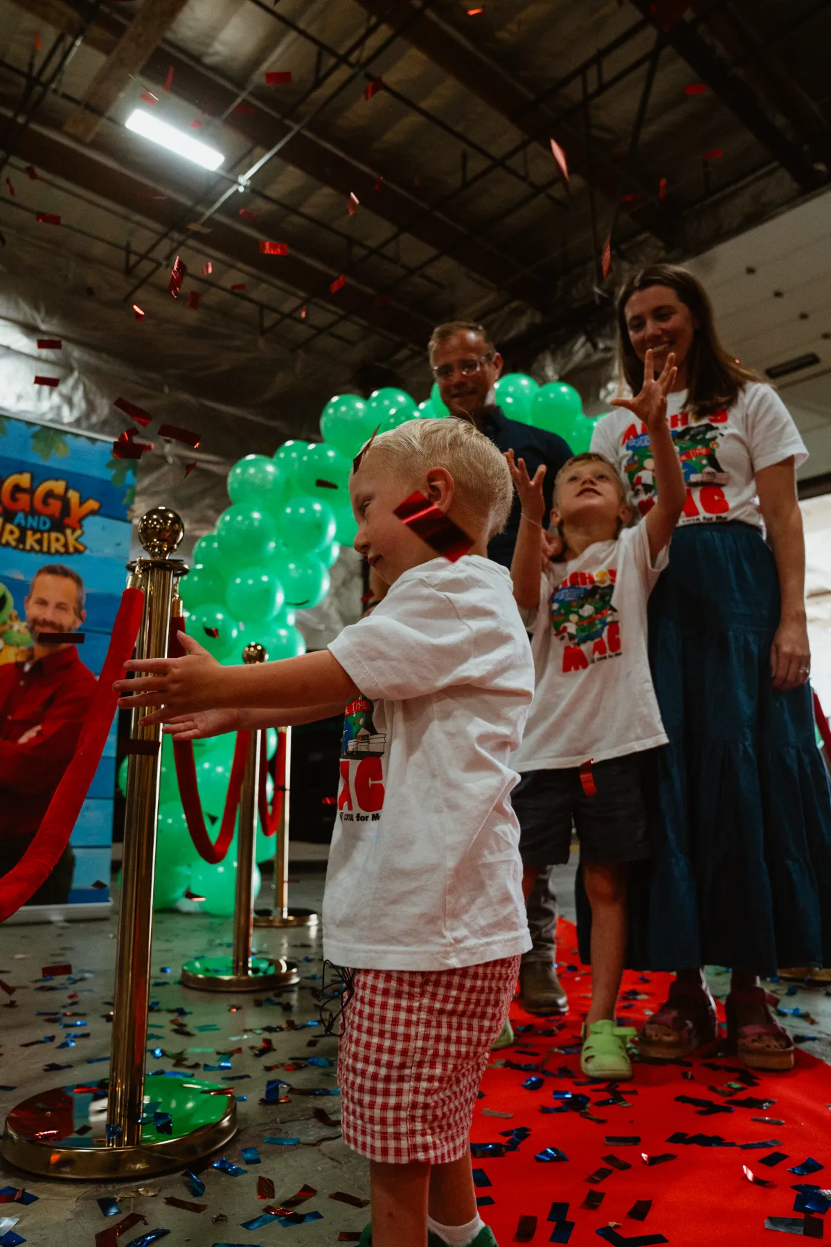 A young Make-A-Wish recipient arriving at the Iggy and Mr. Kirk treehouse to a red carpet and confetti with his family