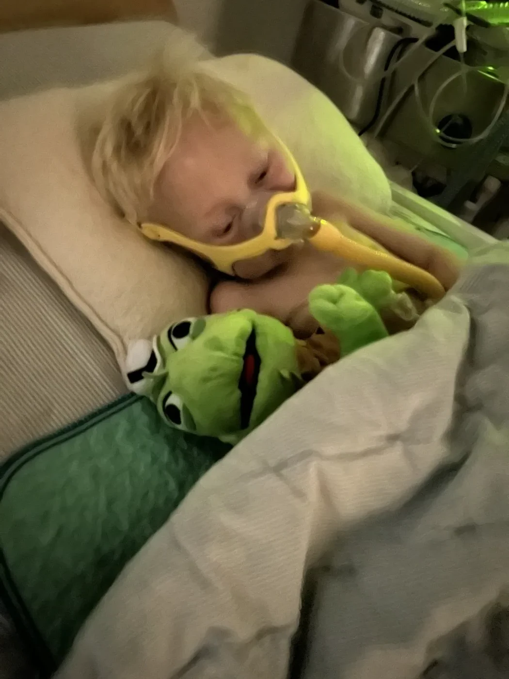 The Make-A-Wish recipient resting with his Iggy plush during treatment